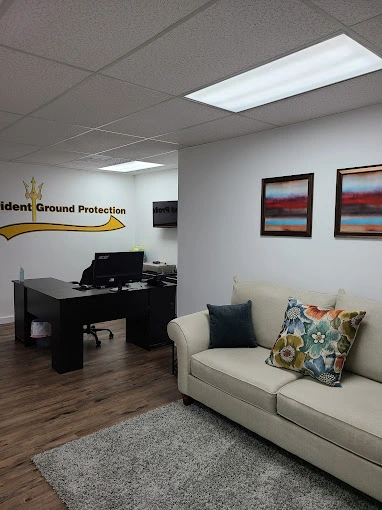 an office space with a desk, chair, a couch, and some decorative items